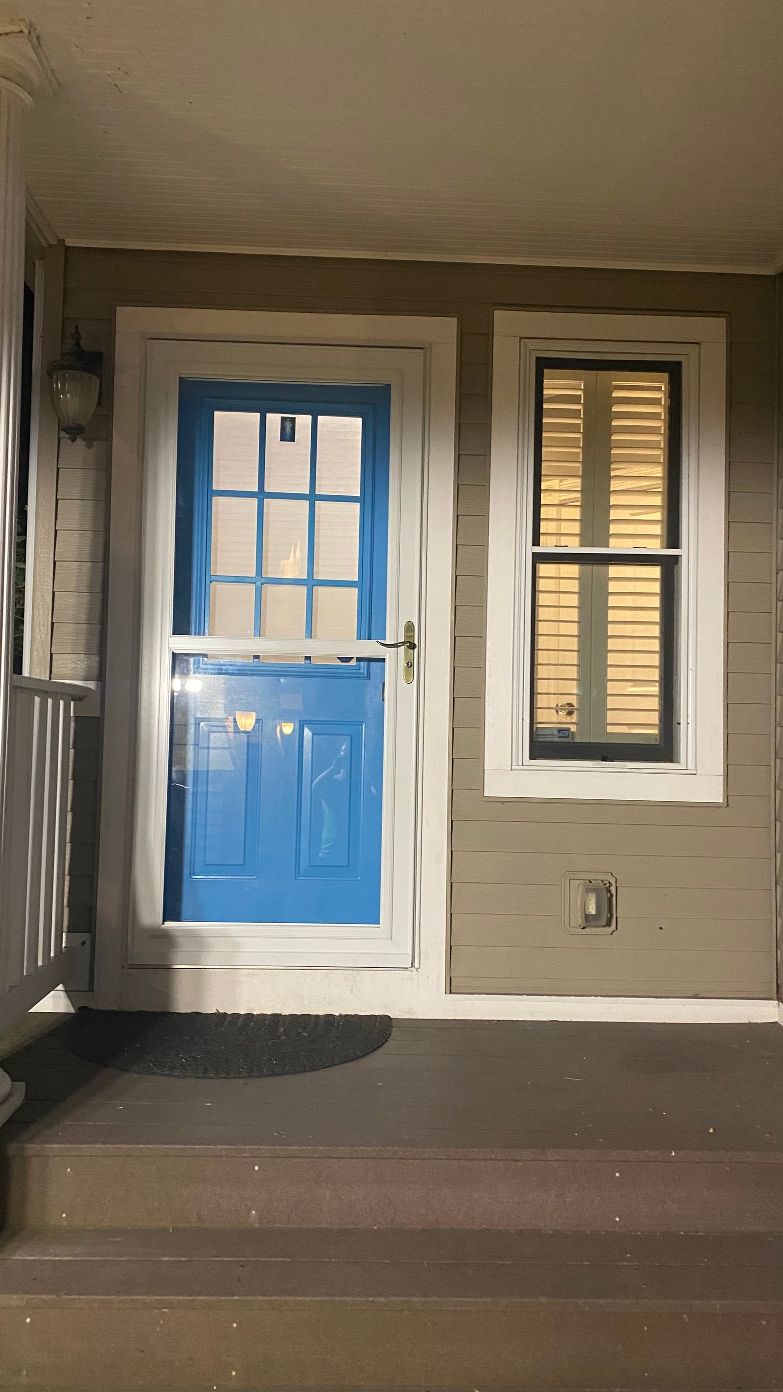 After, night wide shot: porch with the new storm door installed